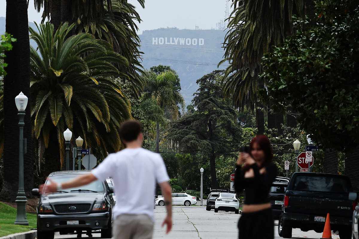A person is recorded with the Hollywood sign in the background in May, after President Donald Trump announced a 100% tariff on films made outside of the U.S. Trump has not followed through on imposing the tariff, saying all options are on the table to "Make Hollywood Great Again."